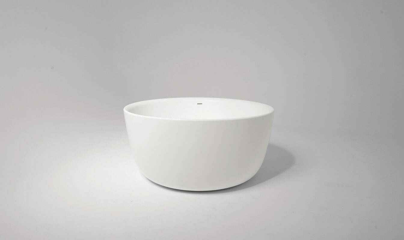 Front view of the Allure Xonyx™ stone bath in a studio in black and white